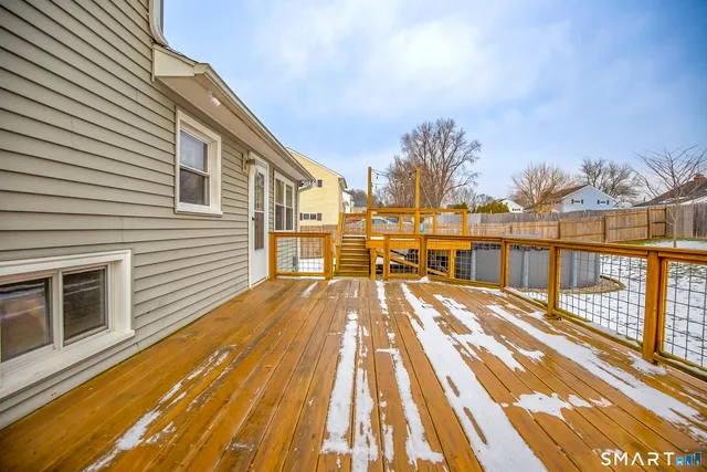 a view of a balcony with wooden floor and outdoor space