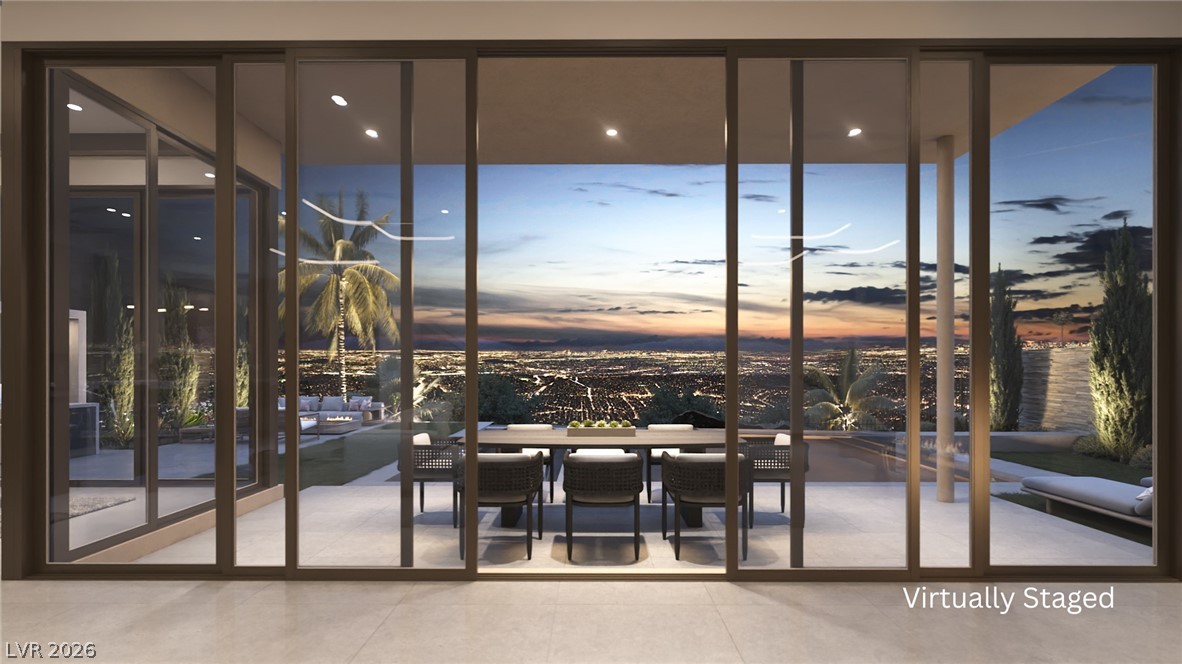 543 Overlook Rim Drive Henderson, NV 89012 - Photo 5 of 19 Uninterrupted city light vistas from an expansive patio through a wall of sliding glass doors.