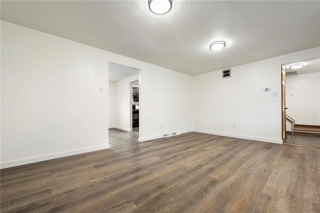 201 Joe Cain Road Bulger, PA 15019 - Photo 23 of 49 a view of an empty room with wooden floor and cabinets