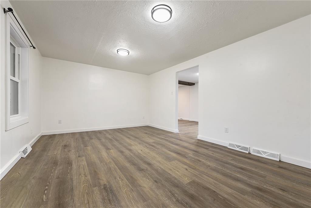 201 Joe Cain Road Bulger, PA 15019 - Photo 27 of 49 an empty room with wooden floor and windows