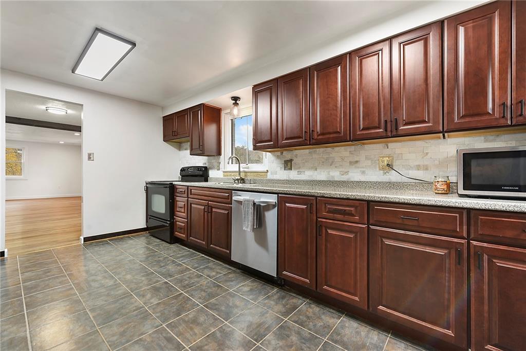 201 Joe Cain Road Bulger, PA 15019 - Photo 29 of 49 a kitchen with stainless steel appliances granite countertop a sink stove and cabinets