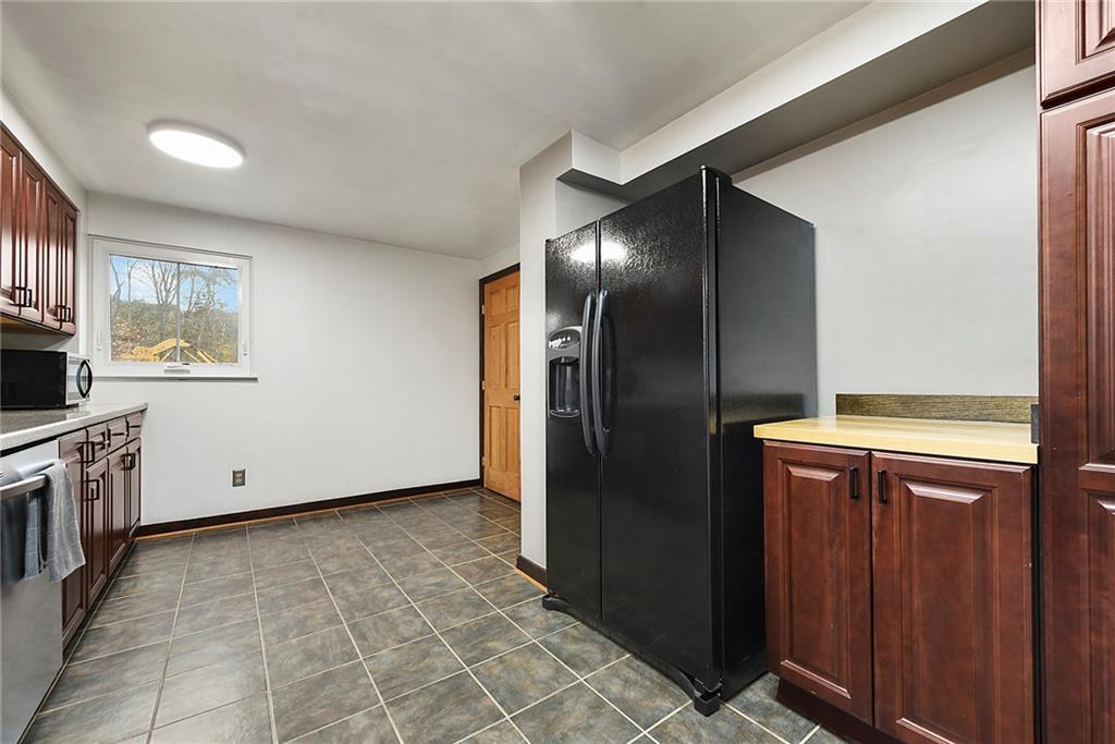 201 Joe Cain Road Bulger, PA 15019 - Photo 31 of 49 a view of a refrigerator in kitchen and wooden cabinets