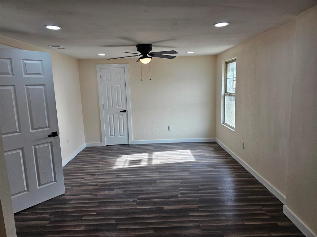 4317 Gram Lane Bellmead, TX 76705 - Photo 14 of 34 a view of an empty room with wooden floor and a window