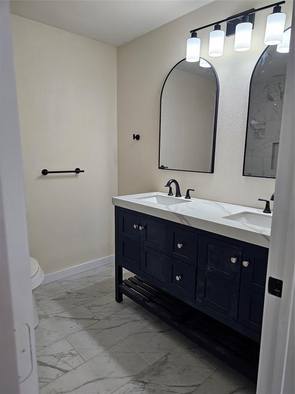 4317 Gram Lane Bellmead, TX 76705 - Photo 17 of 34 a bathroom with a double vanity sink and a mirror