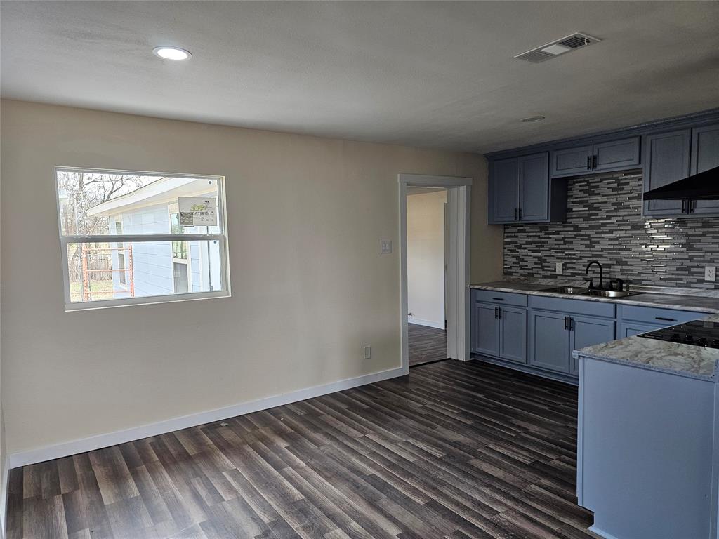 4317 Gram Lane Bellmead, TX 76705 - Photo 2 of 34 a kitchen with wooden floor and a stove top oven