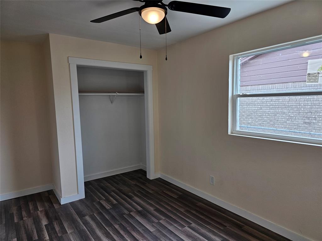 4317 Gram Lane Bellmead, TX 76705 - Photo 22 of 34 a view of an empty room with wooden floor and a window