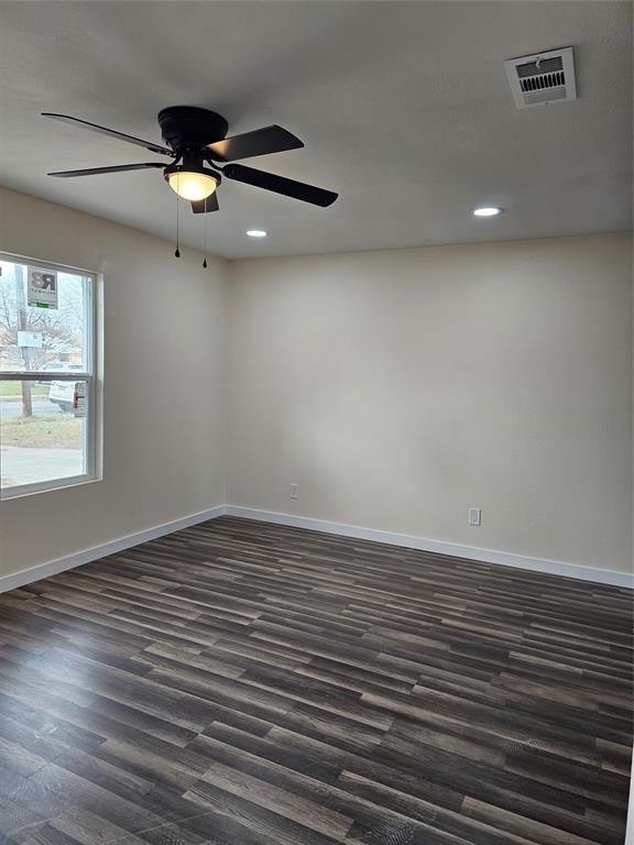 4317 Gram Lane Bellmead, TX 76705 - Photo 7 of 34 an empty room with wooden floor and windows