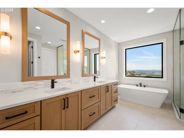 a bathroom with a sink a toilet a mirror and shower