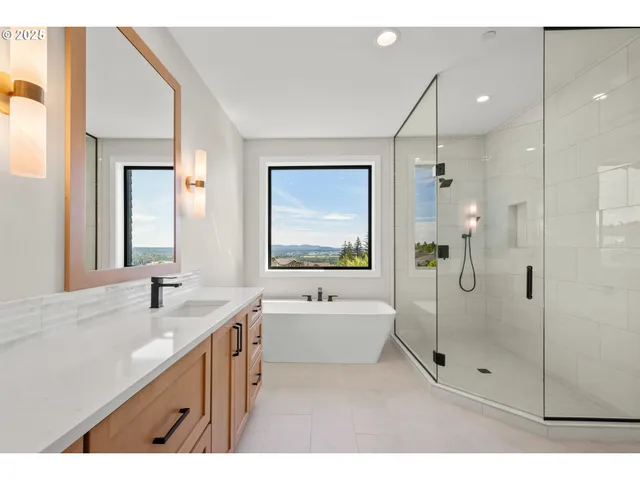 a bathroom with a tub sink and mirror