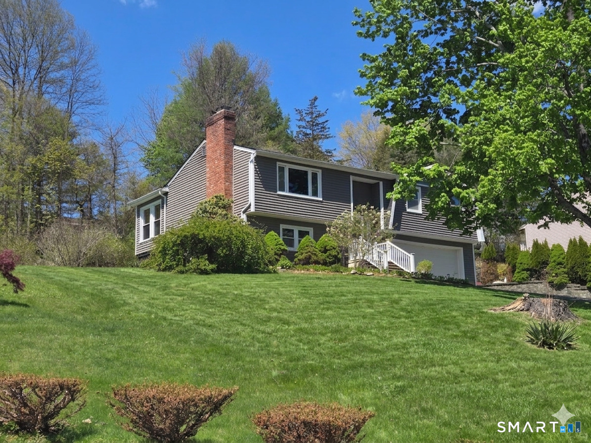 1004 Hickory Hill Road Thomaston, CT 06787 - Photo 7 of 23 a view of a house with a big yard potted plants and large tree