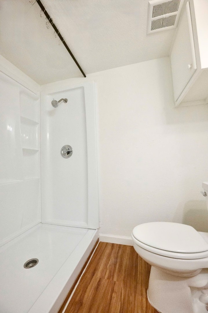 12048 Beechnut Street Houston, TX 77072 - Photo 11 of 21 a bathroom with a toilet and shower