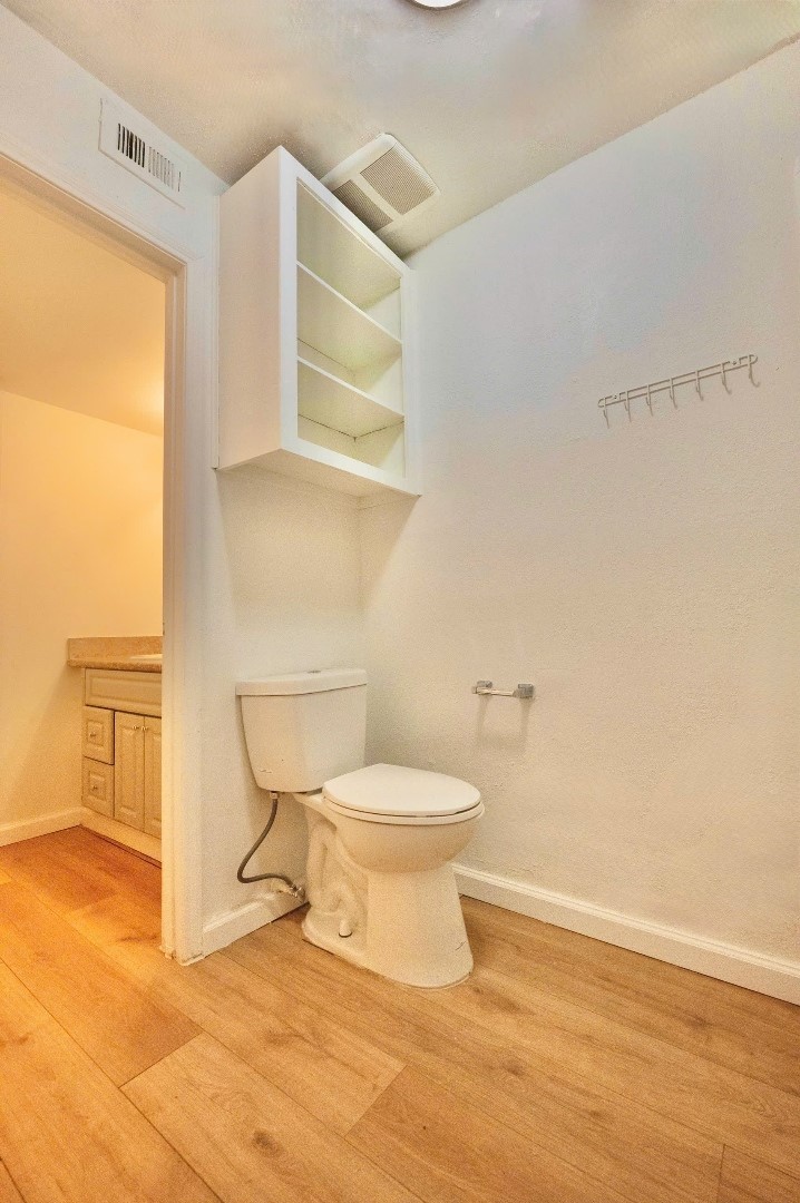 12048 Beechnut Street Houston, TX 77072 - Photo 13 of 21 a white toilet sitting next to a bathroom sink and a window