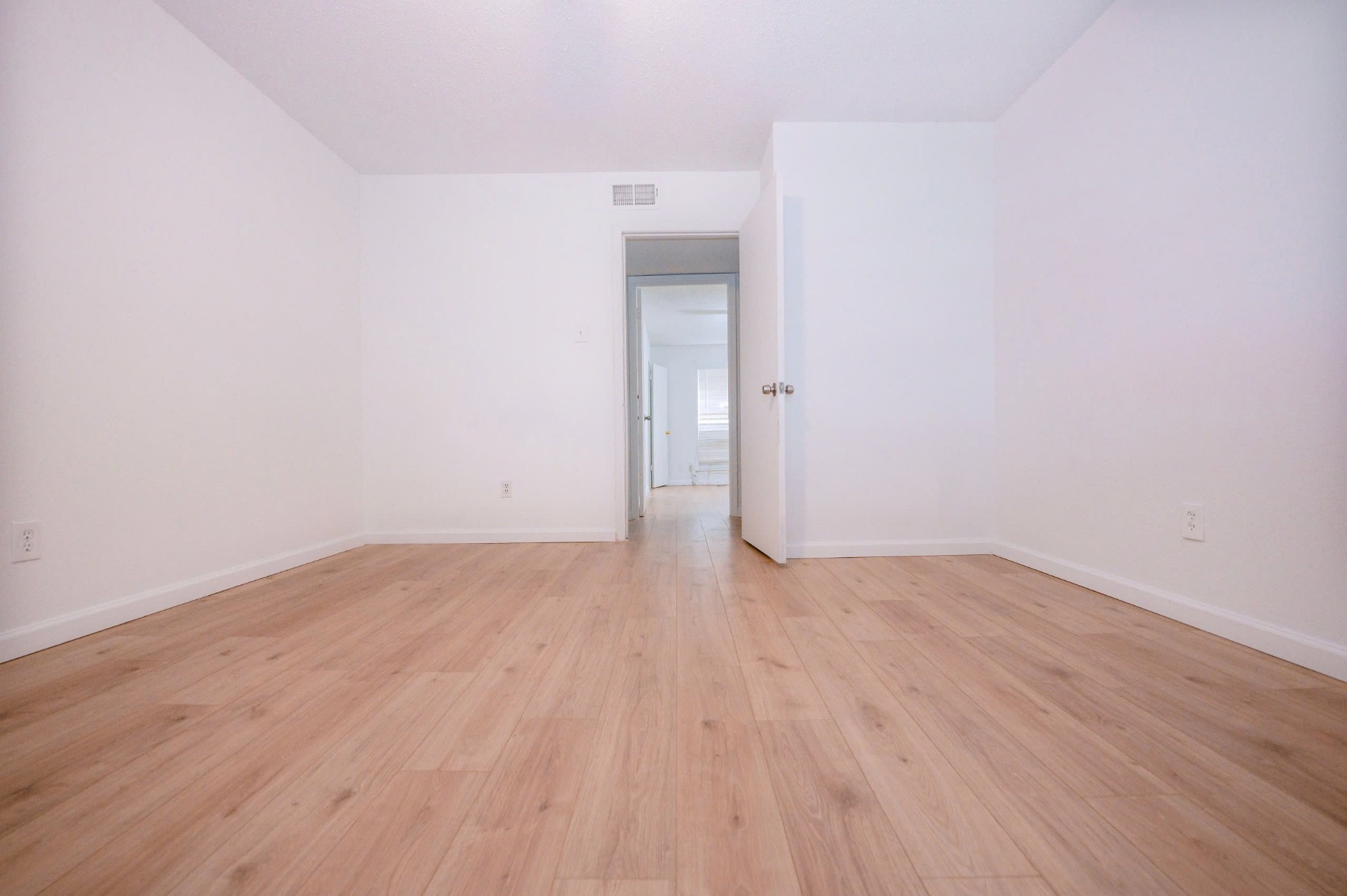 12048 Beechnut Street Houston, TX 77072 - Photo 4 of 21 a view of an empty room with wooden floor and a window