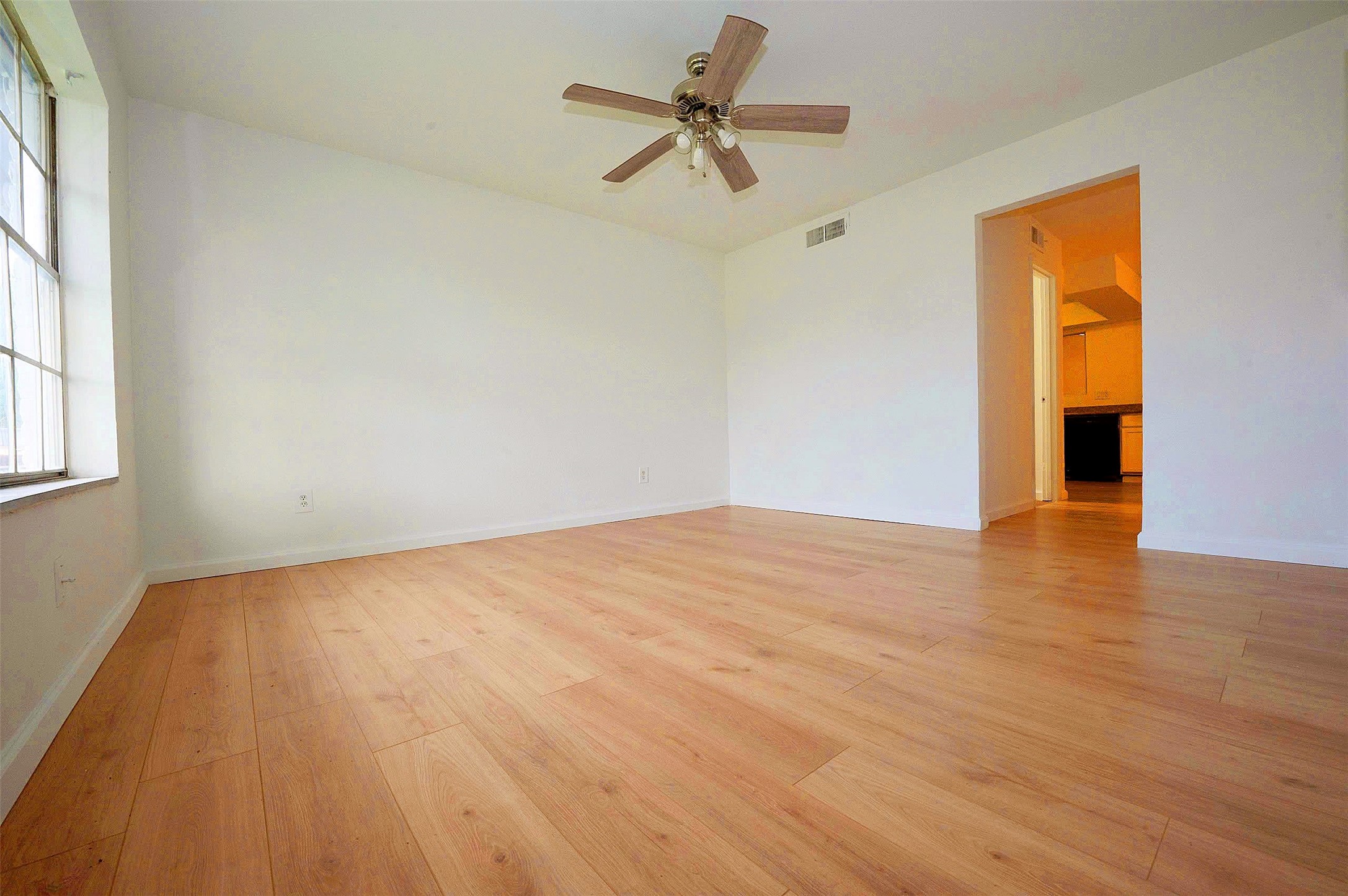 12048 Beechnut Street Houston, TX 77072 - Photo 5 of 21 a view of empty room with wooden floor and fan