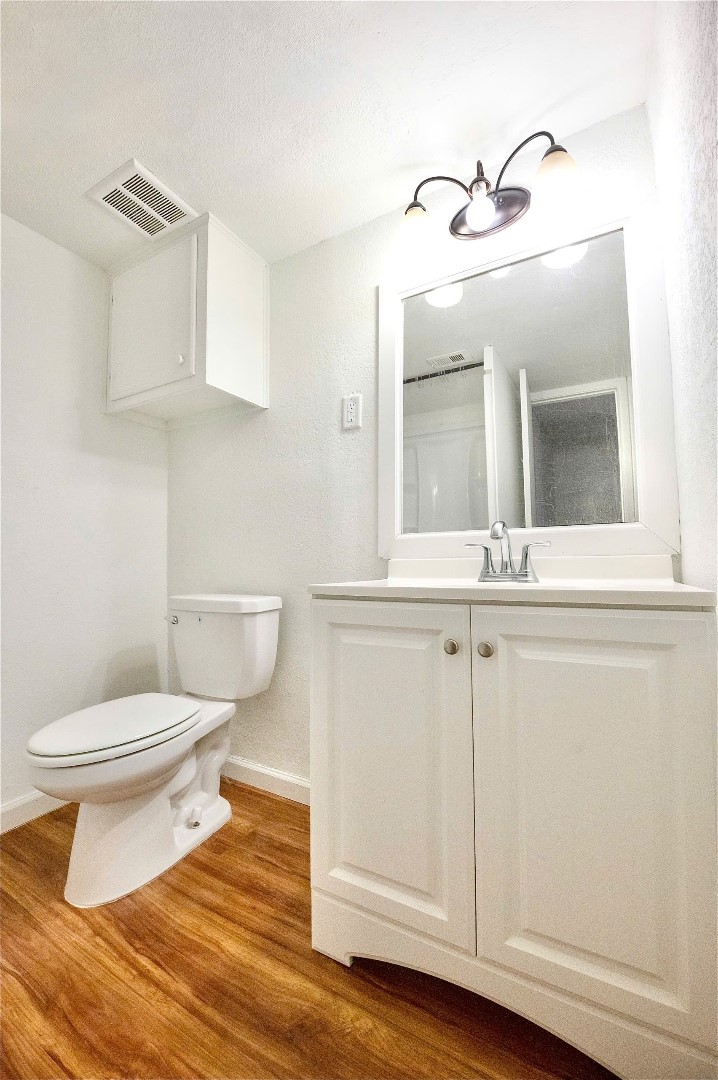 12048 Beechnut Street Houston, TX 77072 - Photo 9 of 21 a bathroom with a toilet sink and mirror