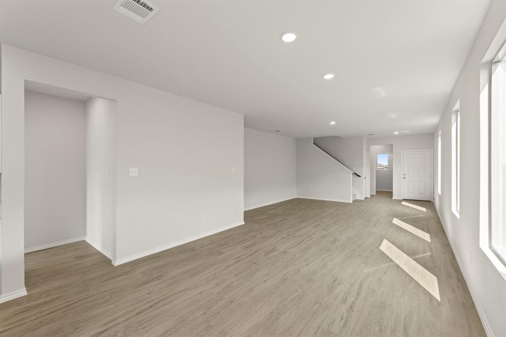 1702 Potomac Lane Blue Ridge, TX 75424 - Photo 14 of 27 an empty room with wooden floor and windows