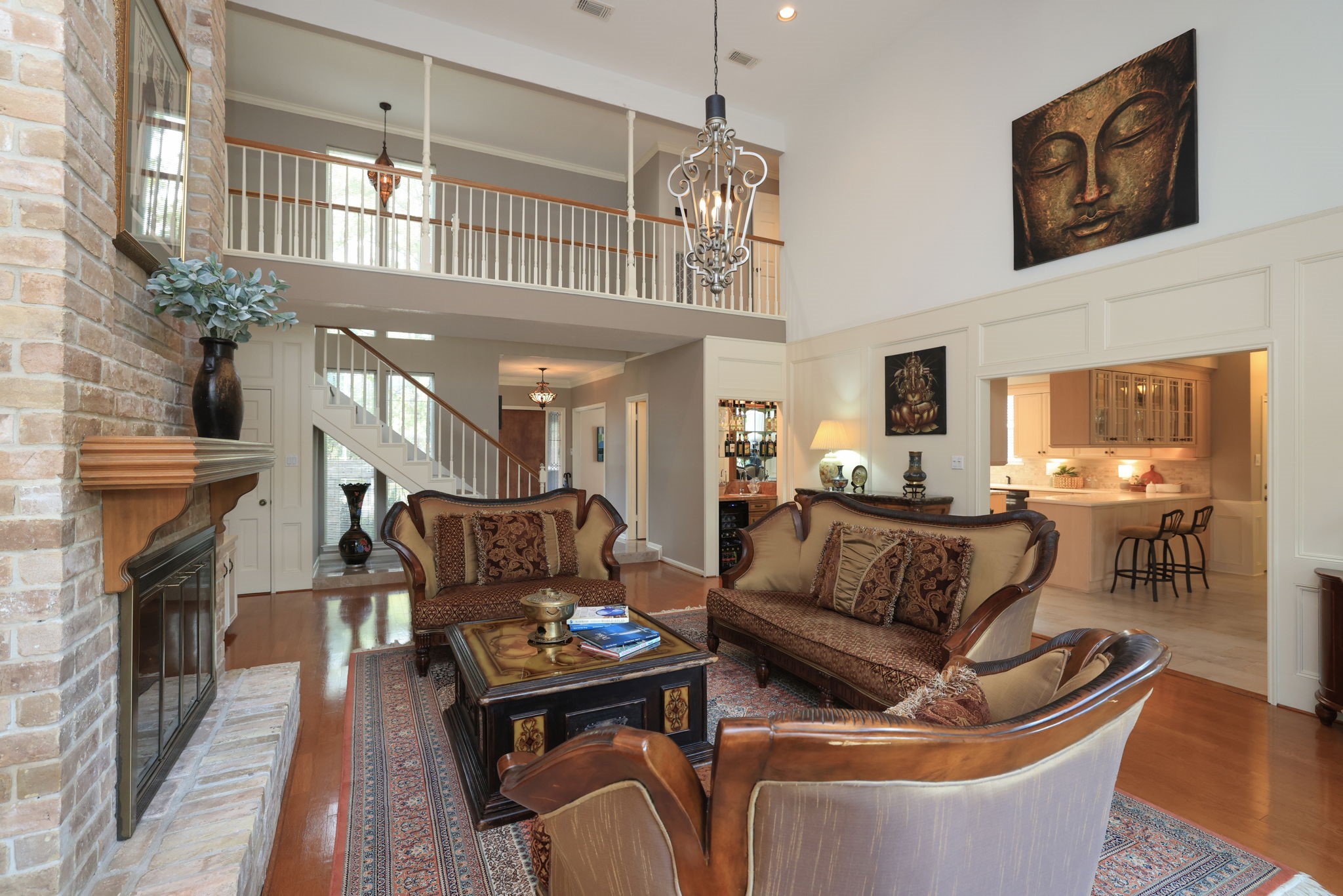 16123 Chasemore Drive Spring, TX 77379 - Photo 12 of 50 This view of the spacious living room features an open layout connecting to a bright kitchen, and warm hardwood floors, creating an inviting atmosphere.