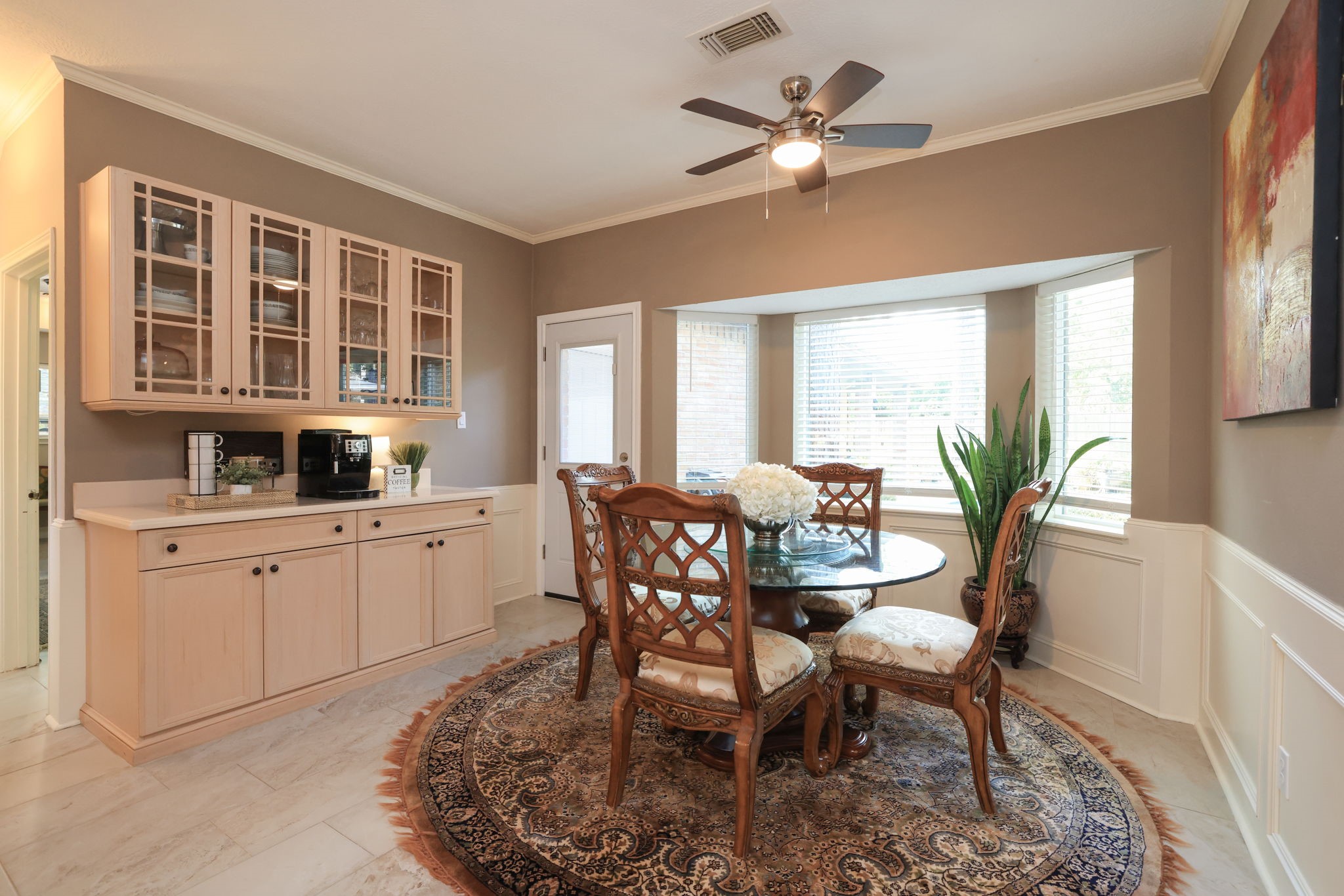 16123 Chasemore Drive Spring, TX 77379 - Photo 15 of 50 This breakfast area has ample natural light from a large double pane bay windows, a ceiling fan, and built-in cabinets for storage, creating a perfect setting for intimate meals and gatherings.