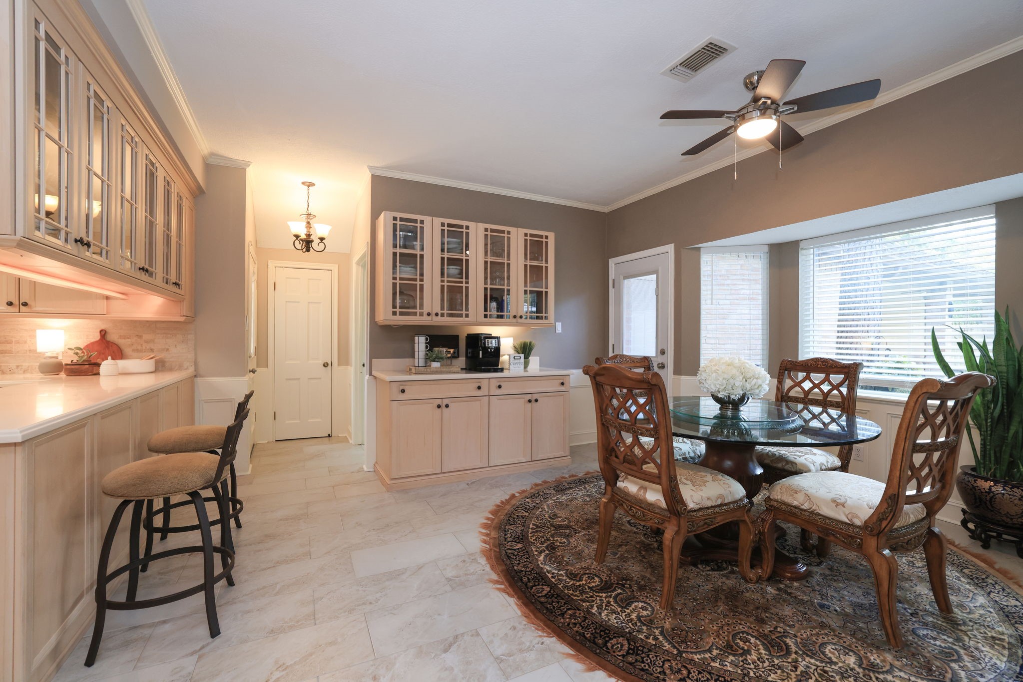 16123 Chasemore Drive Spring, TX 77379 - Photo 16 of 50 This cozy breakfast nook has a long counter with storage below as well as glass front cabinets above. The new door leads out to the back yard.