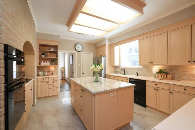 a kitchen with a sink stove and cabinets