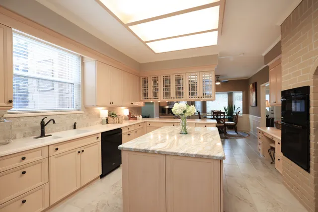a large white kitchen with a large window