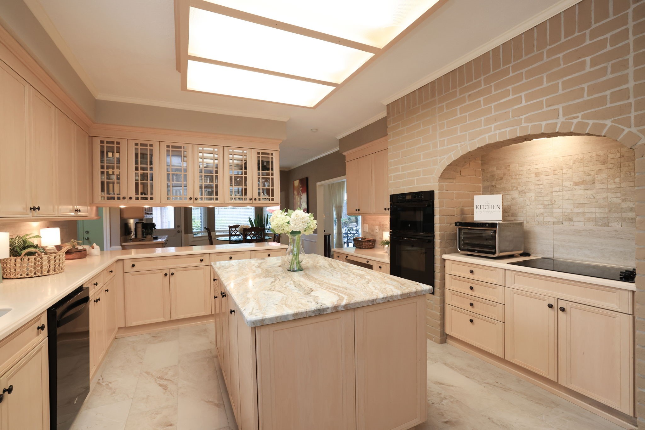 16123 Chasemore Drive Spring, TX 77379 - Photo 21 of 50 This view of the kitchen shows the recessed ceiling light, and glass-front cabinets that offer stylish storage. The breakfast area is seen in the distance.