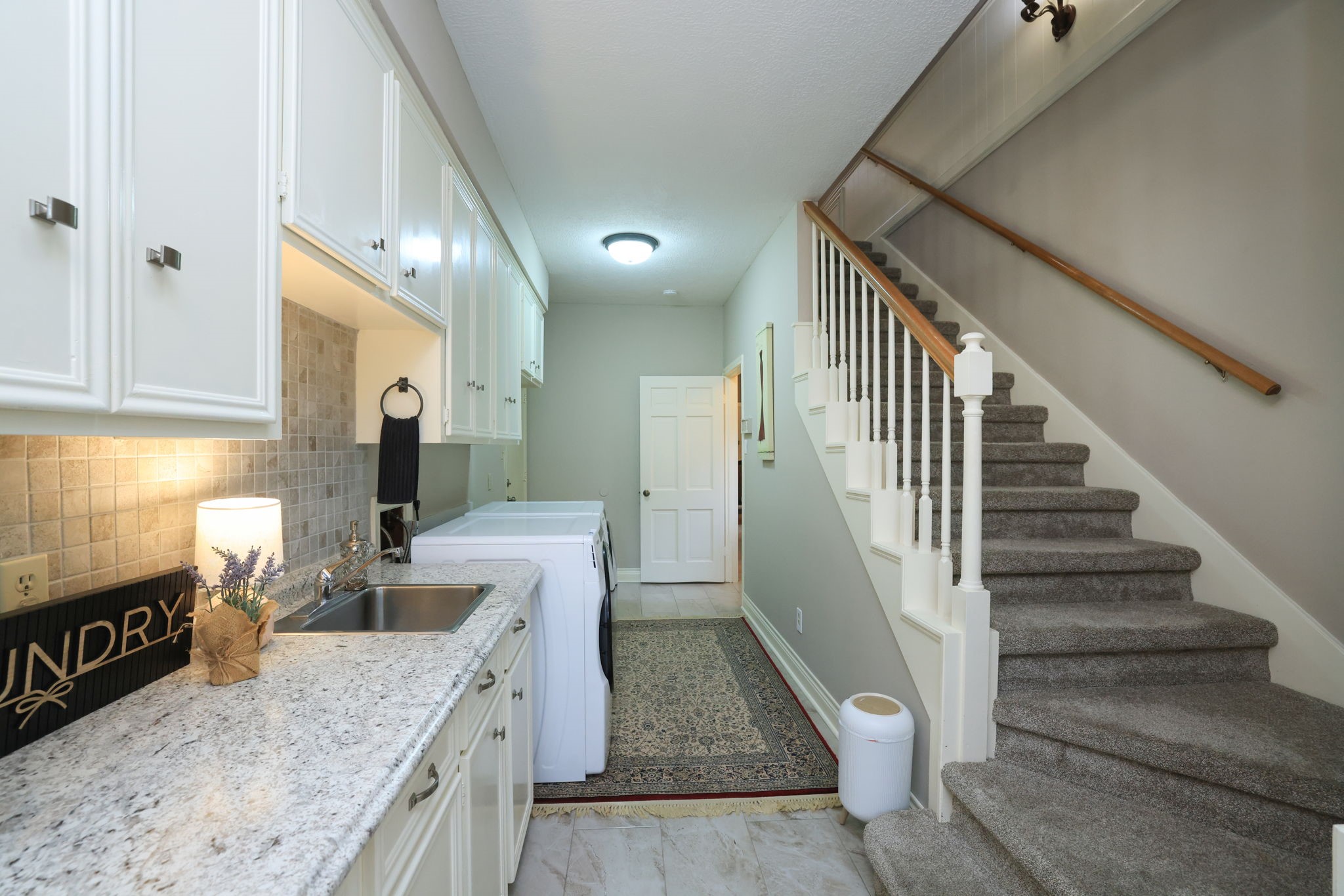 16123 Chasemore Drive Spring, TX 77379 - Photo 23 of 50 This is another view of the laundry area with sink and a second staircase leading to the upstairs game room.