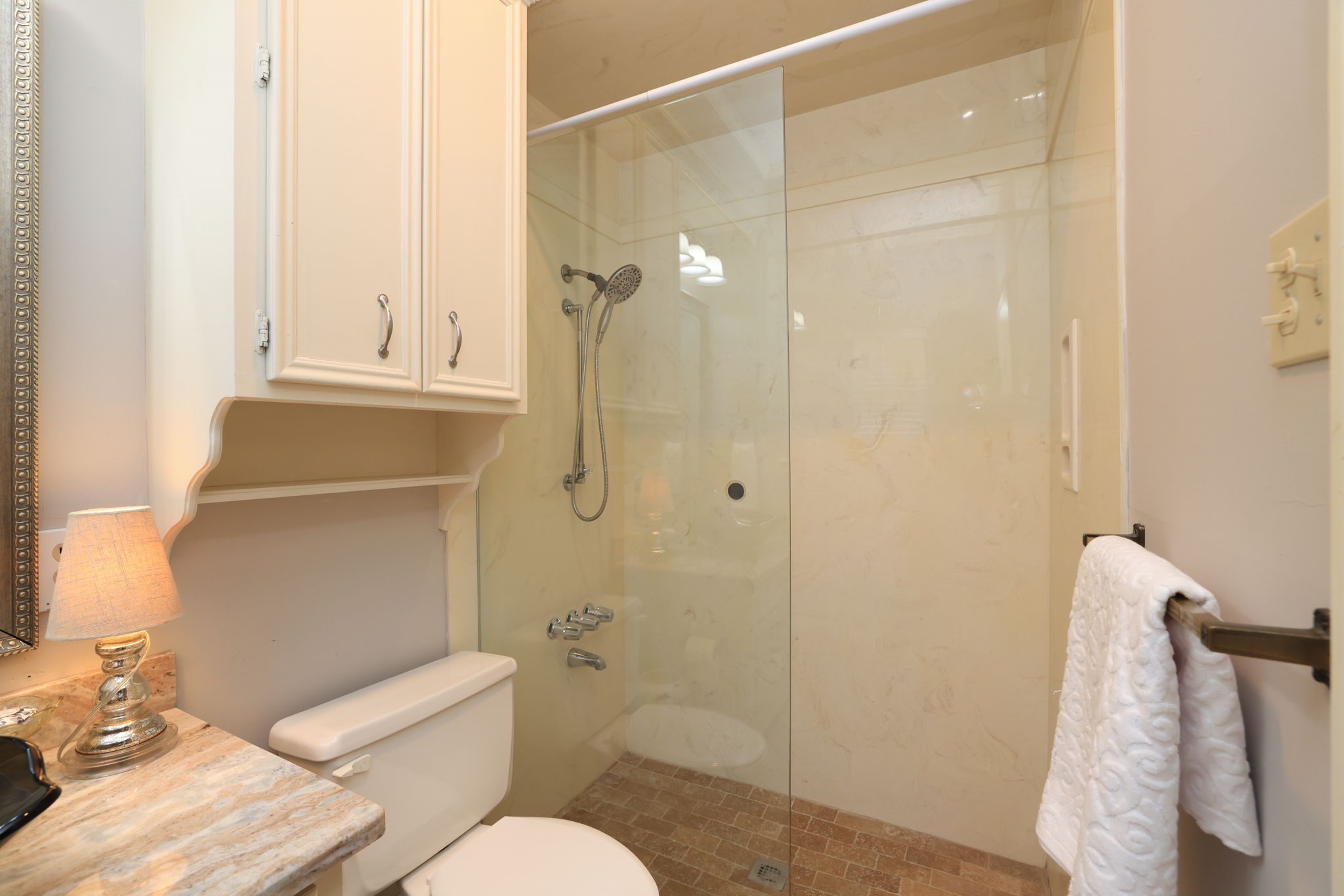 16123 Chasemore Drive Spring, TX 77379 - Photo 29 of 50 This full bathroom in the second bedroom down. features a cozy, well-lit space with a glass-enclosed shower, tiled floor, and granite marble countertop.