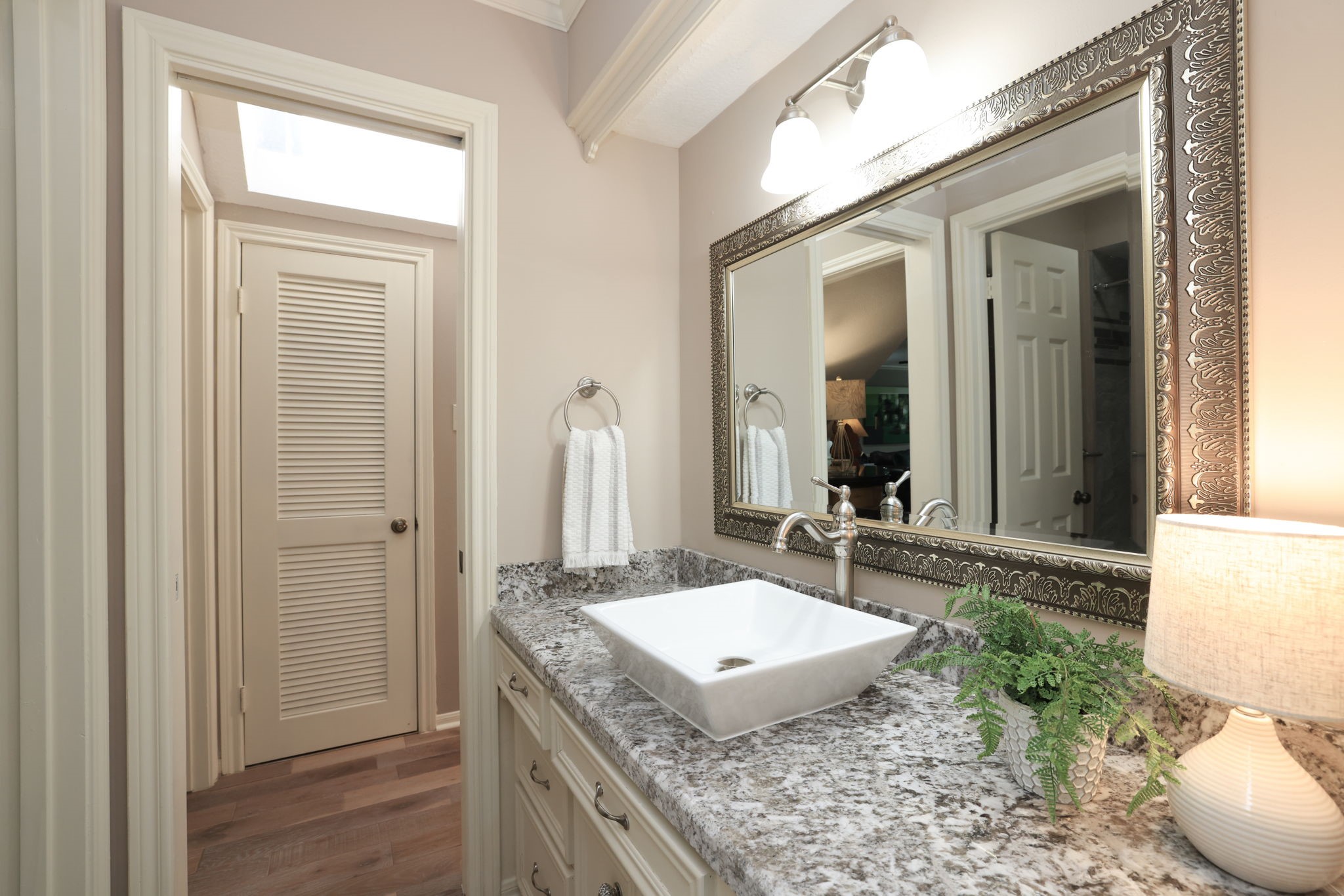 16123 Chasemore Drive Spring, TX 77379 - Photo 34 of 50 This bathroom features a modern design with a large, ornate mirror and a stylish granite countertop with vessel sink.