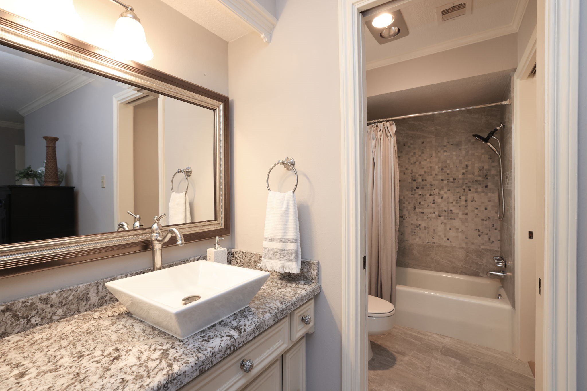 16123 Chasemore Drive Spring, TX 77379 - Photo 39 of 50 Al bathrooms in the home have been remodeled including this bathroom with granite vanity, vessel sink and remodeled tub walls.