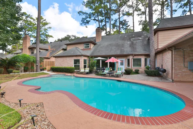 a view of a house with swimming pool yard and patio