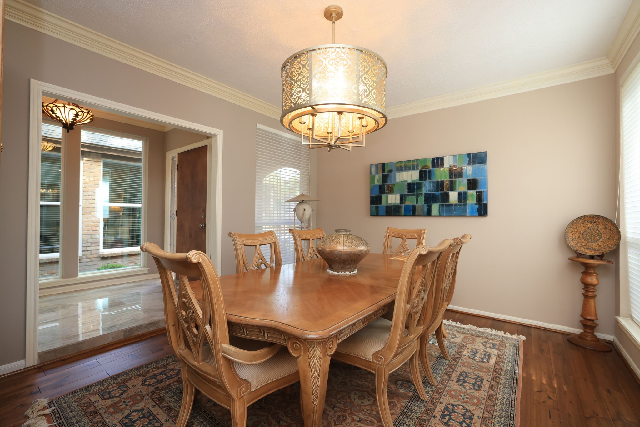 16123 Chasemore Drive Spring, TX 77379 - Photo 6 of 50 The elegant dining room is to the left as you enter the home and includes a stylish chandelier and hardwood floors.