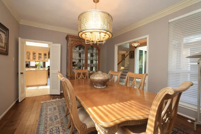 a view of a dining room with furniture wooden floor and chandelier