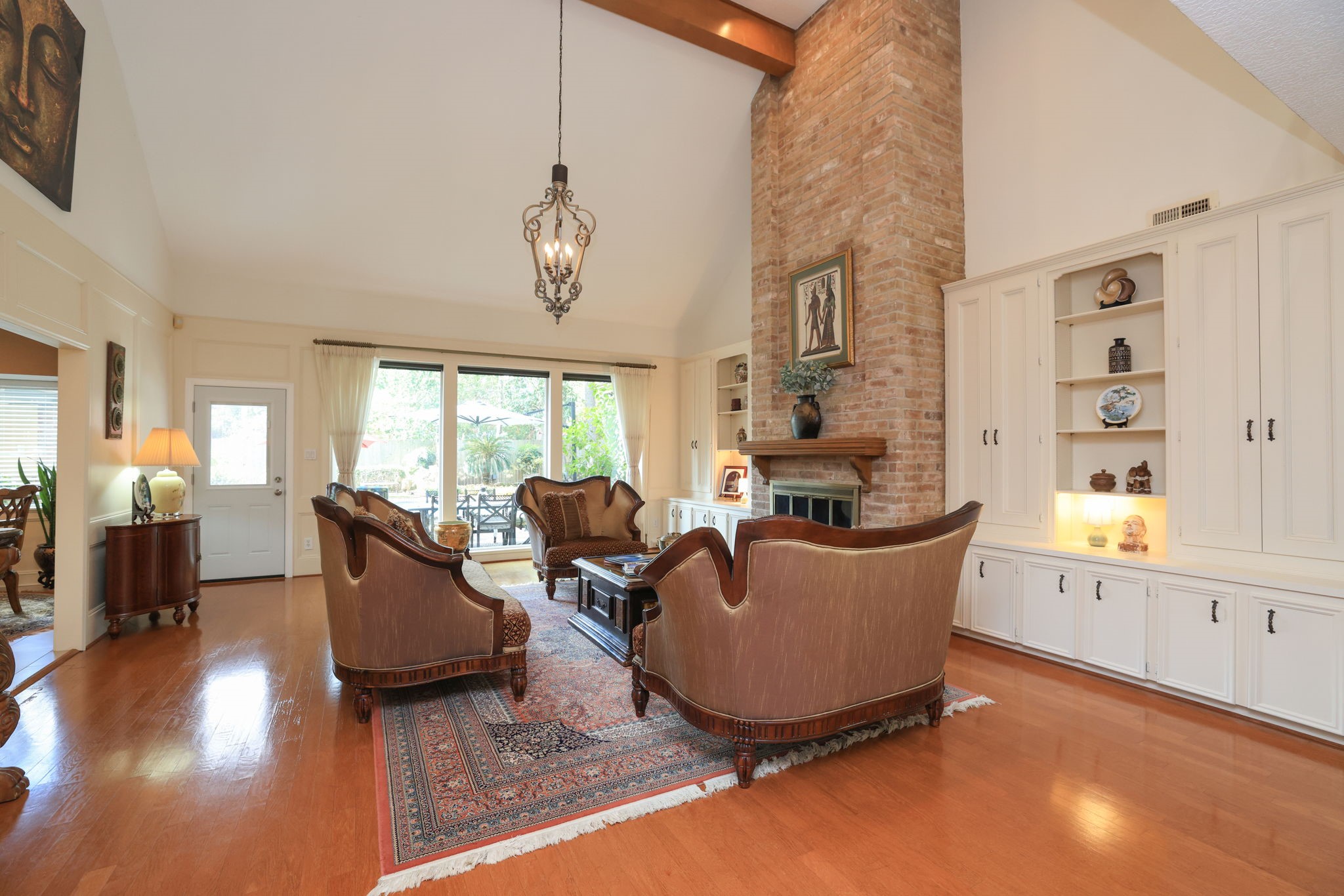 16123 Chasemore Drive Spring, TX 77379 - Photo 9 of 50 The living area is amazing with vaulted ceiling, wood floors and natural wood beam.