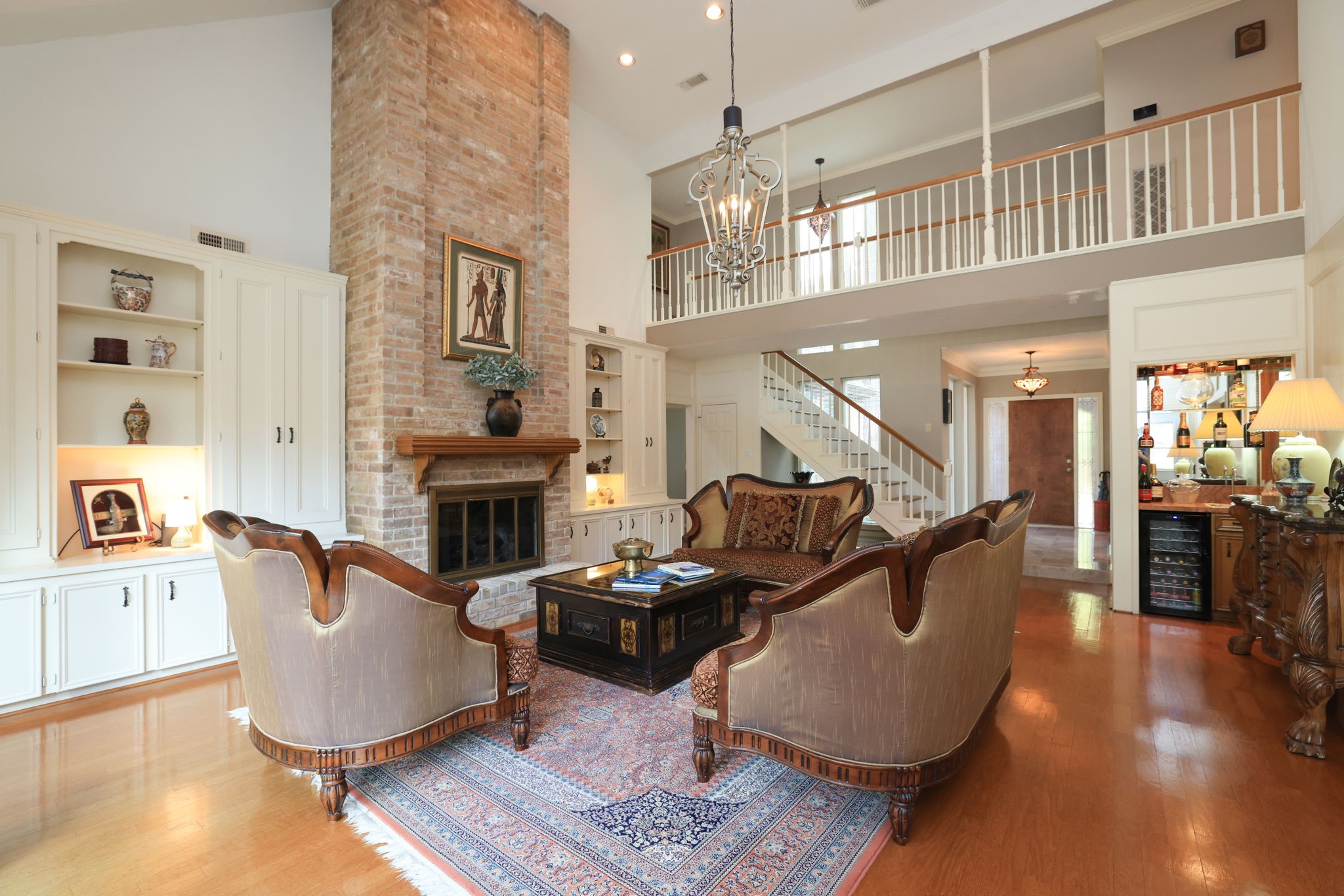 16123 Chasemore Drive Spring, TX 77379 - Photo 10 of 50 A two story brick gas fireplace is the focal point of the living area and is framed by custom shelves and cabinets.