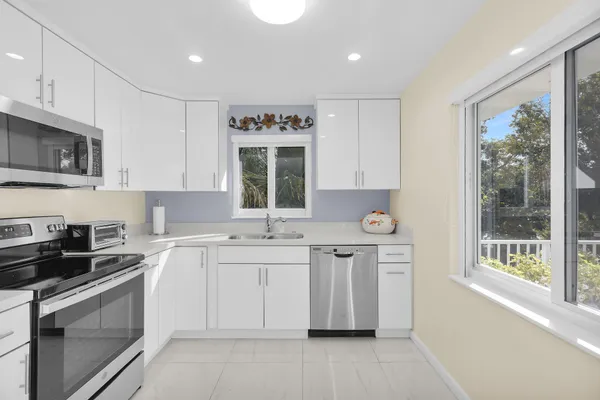 a kitchen with stainless steel appliances granite countertop a sink and a stove