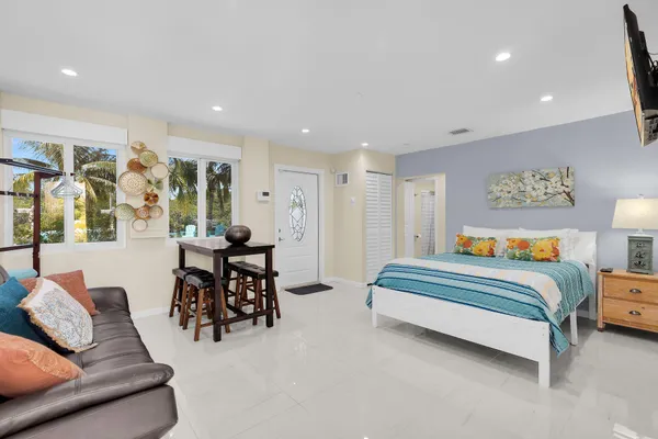 a bedroom with a bed and a large window
