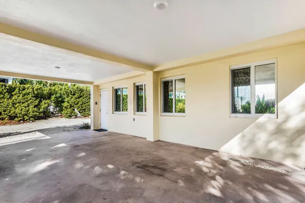 a view of backyard of house with outdoor seating