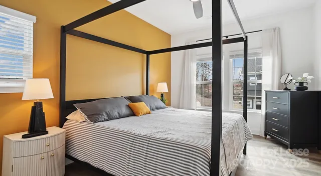 a bedroom with a bed and a lamp next to a window