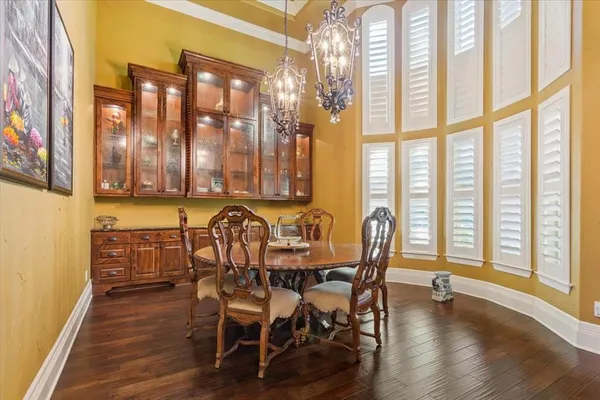 a dining room with furniture window and wooden floor