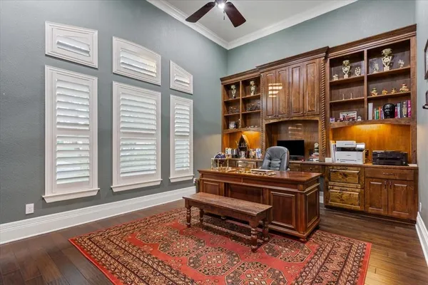 a living room with furniture lamps and wooden floor