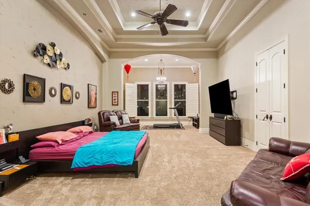 a bedroom with a bed and glass door