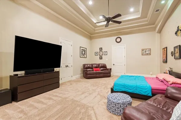 a bedroom with furniture and a flat screen tv