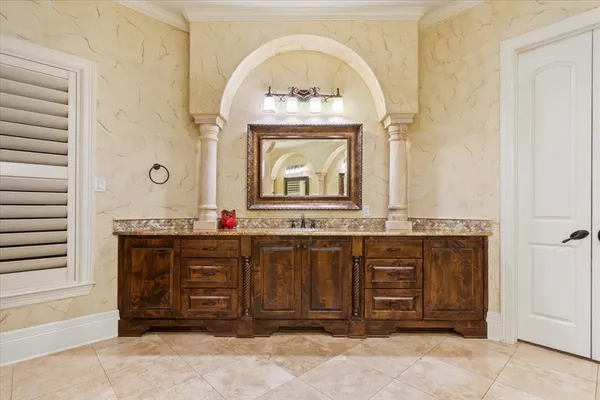 a bathroom with a granite countertop sink a mirror and a bathtub