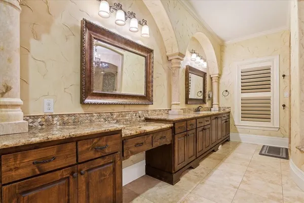 a bathroom with a granite countertop double vanity sink a mirror and a
