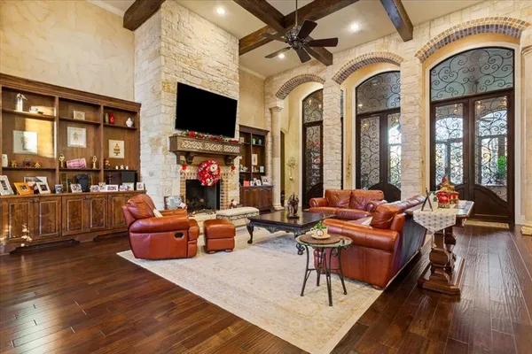 a living room with fireplace furniture and a flat screen tv