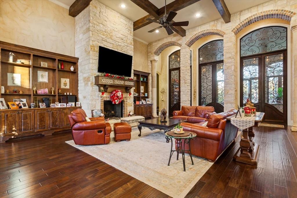 10020 Hidden Bluff Waco, TX 76657 - Photo 2 of 39 a living room with fireplace furniture and a flat screen tv