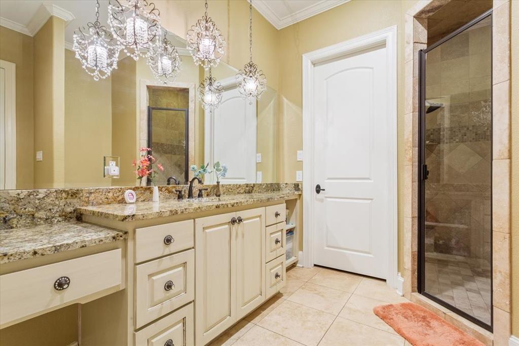 10020 Hidden Bluff Waco, TX 76657 - Photo 25 of 40 a bathroom with a granite countertop sink a mirror and a shower