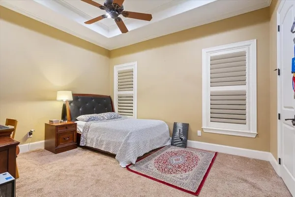 a bedroom with two beds and painted walls