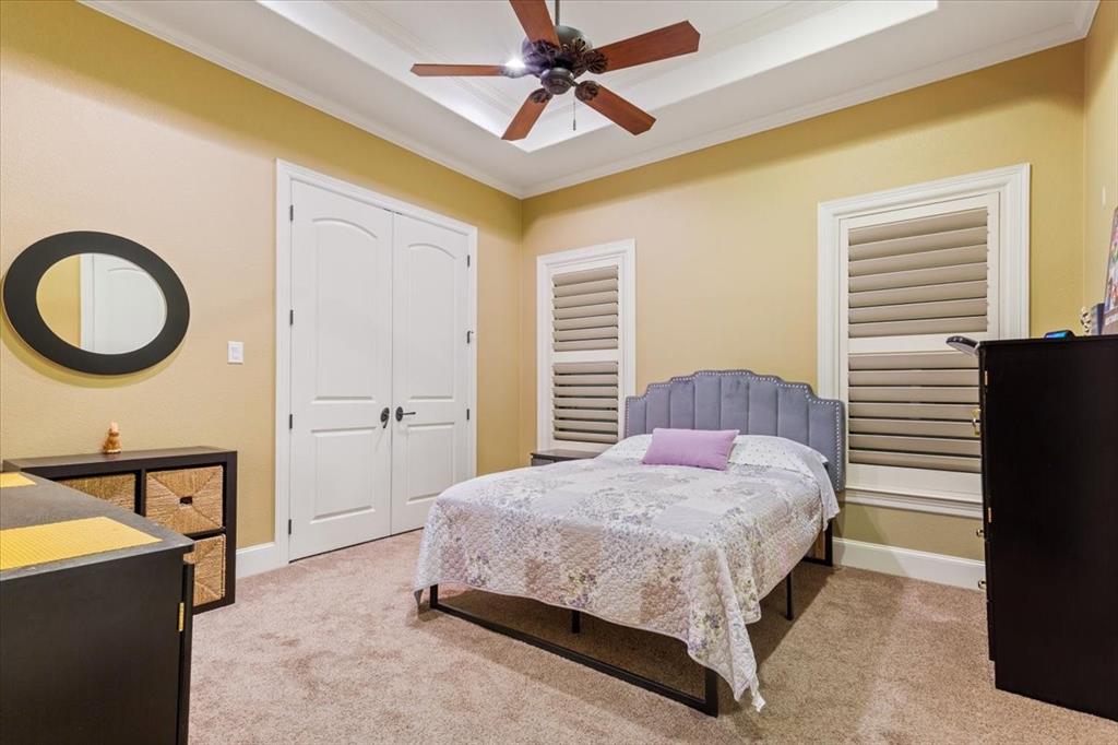 10020 Hidden Bluff Waco, TX 76657 - Photo 29 of 40 a bedroom with a bed a dresser and a chandelier